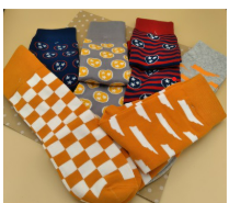 Collection of colorful socks with various patterns on a flat surface.