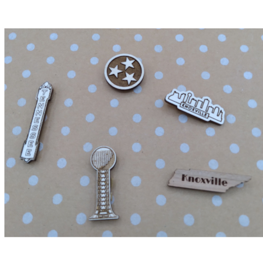 Collection of small metal charms on a polka dot background