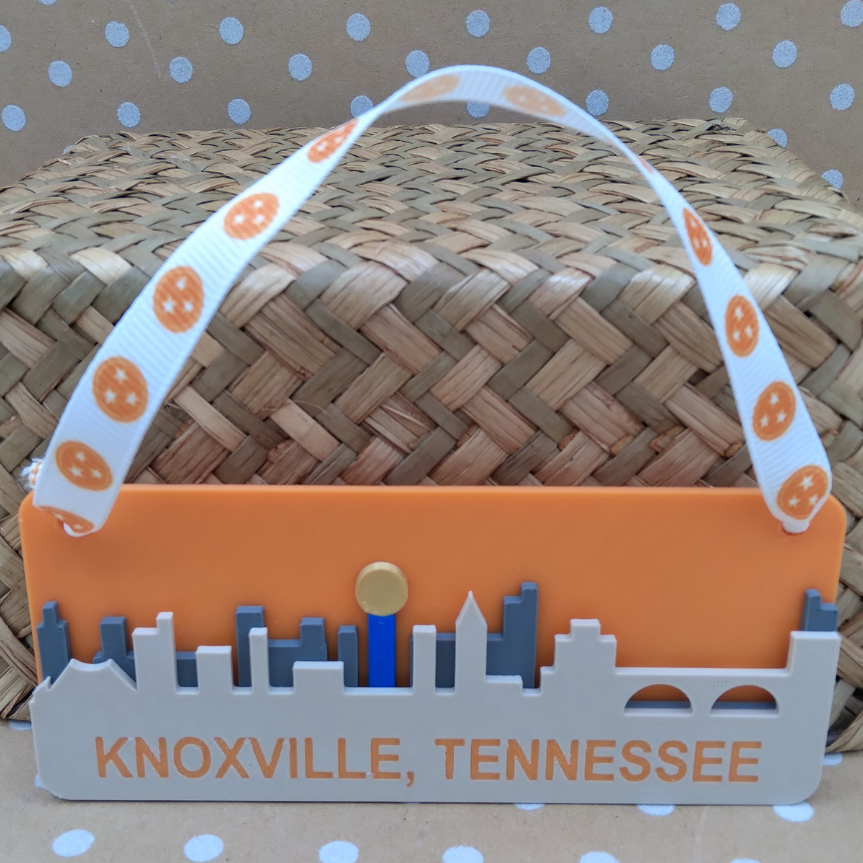 Woven basket with an orange and gray label reading 'Knoxville, Tennessee' on a polka dot background