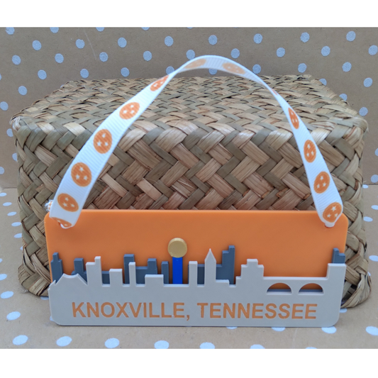 Woven basket with an orange and gray label reading 'Knoxville, Tennessee' on a polka dot background